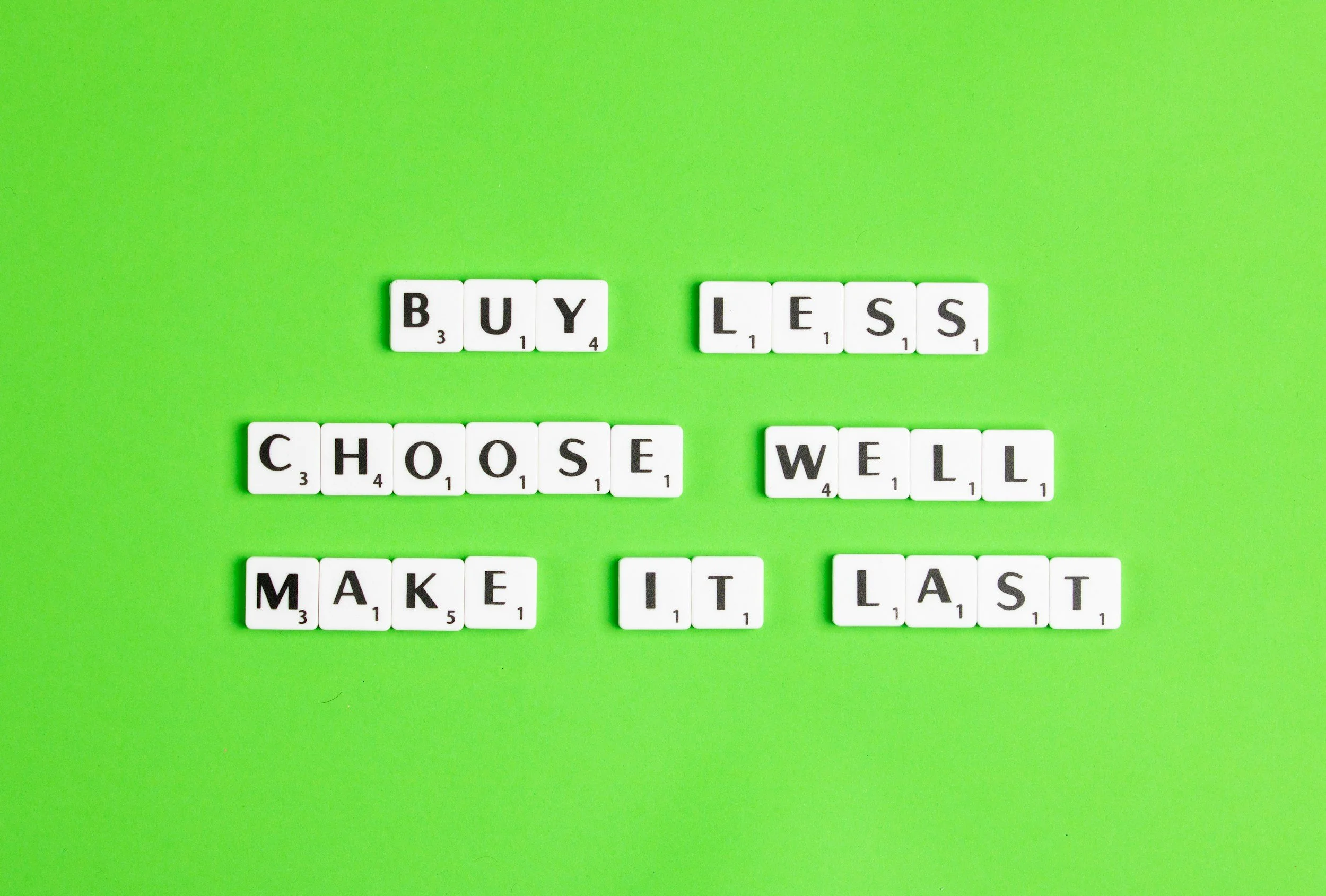 buy less choose well make it last against lime green backgrop