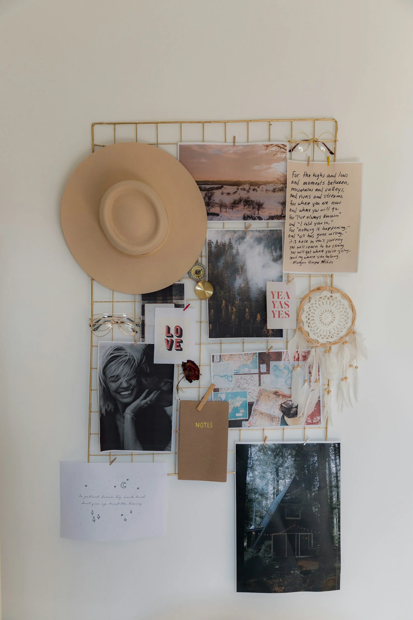 image of vision board with photos pinned to golden grid frame including images, hat, glasses, dreamcatcher and affirmations