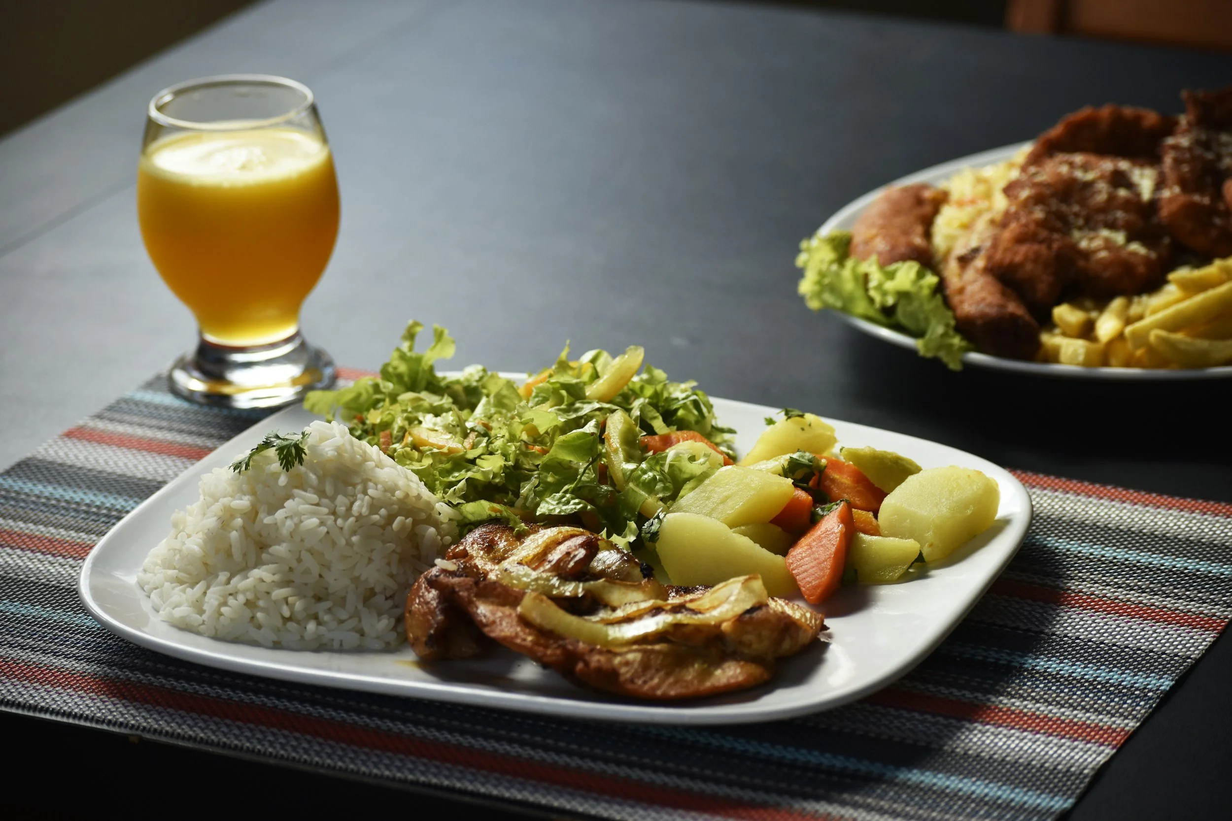 meal with iguana meat on plate with rice salad and potato veggies