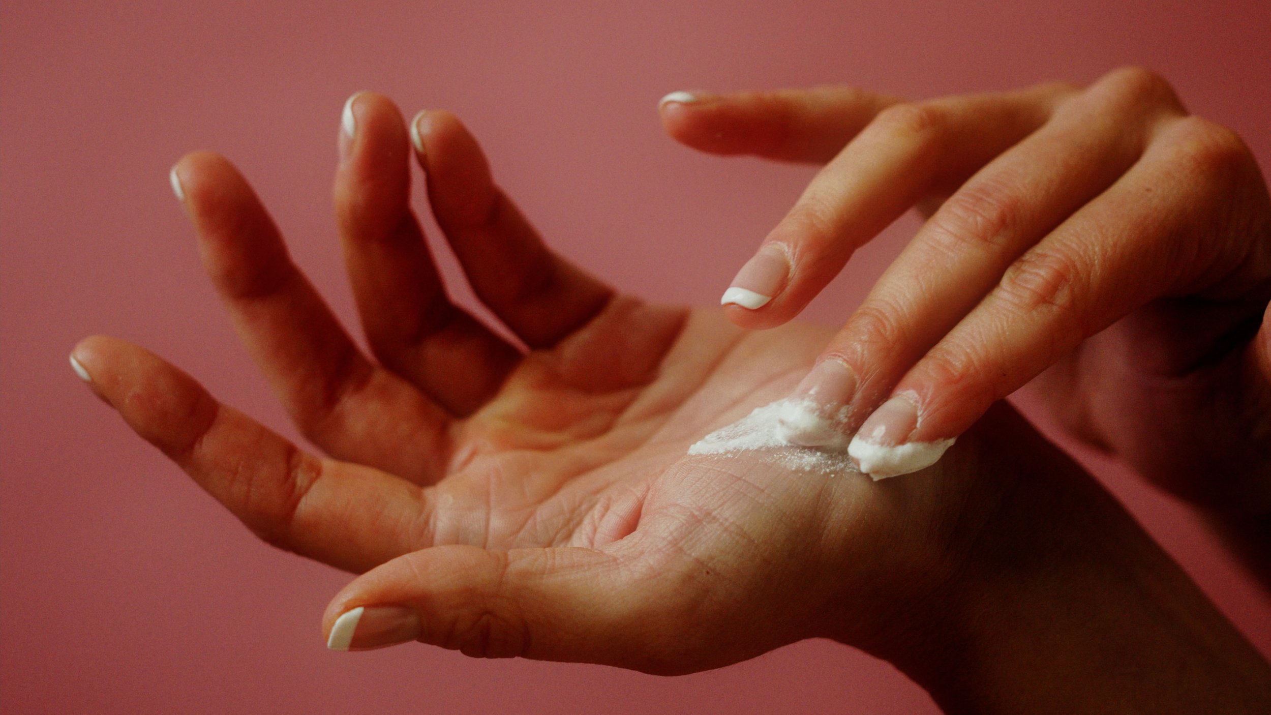 Beauty shot of hands applying lotion in soft light, The Kiln video production