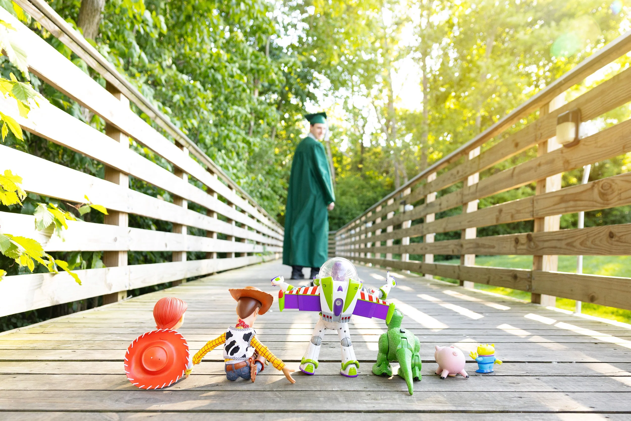 Senior cap and gown photos Novi Michigan toy story figurines