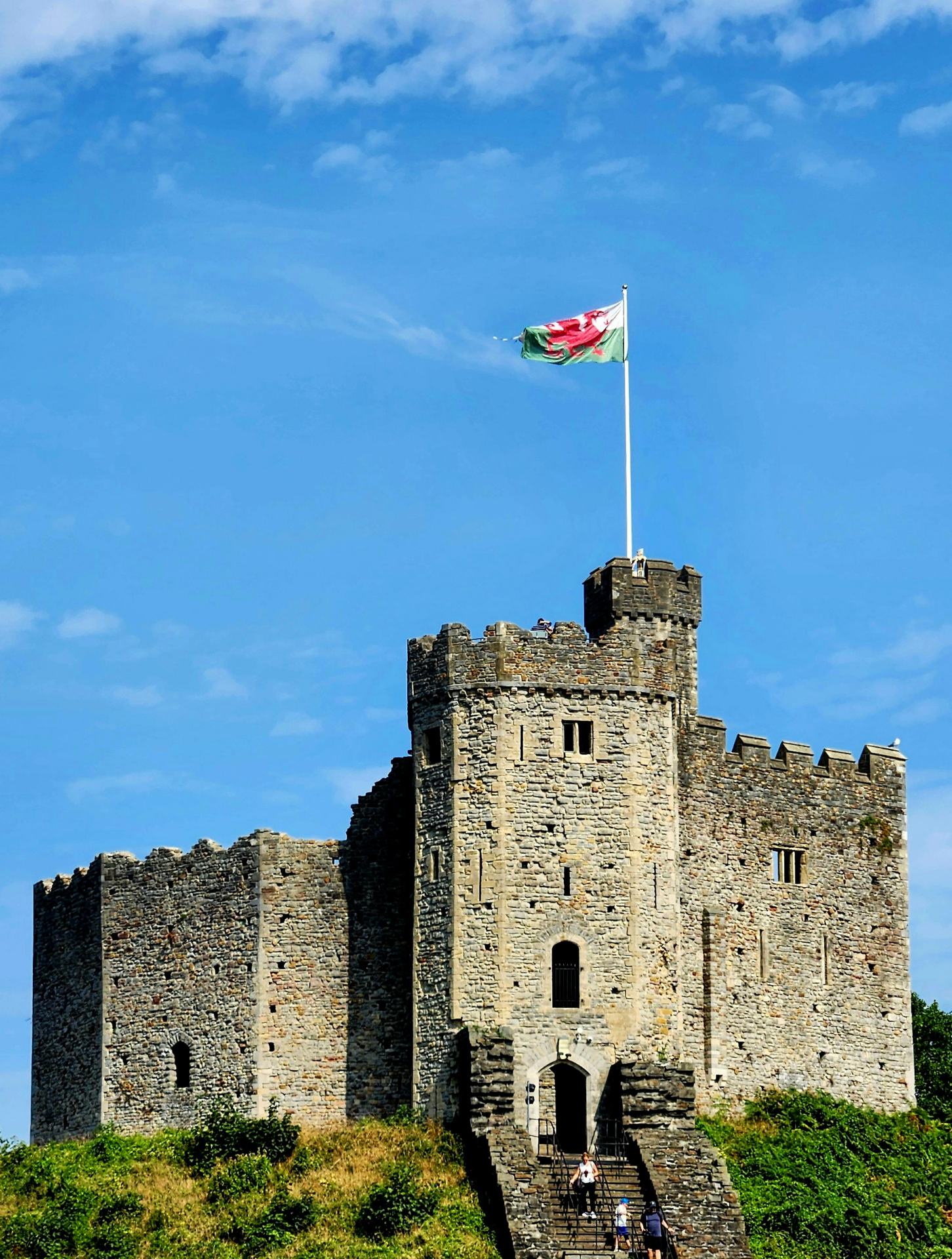welsh castle with a welsh flag waving atop the tower