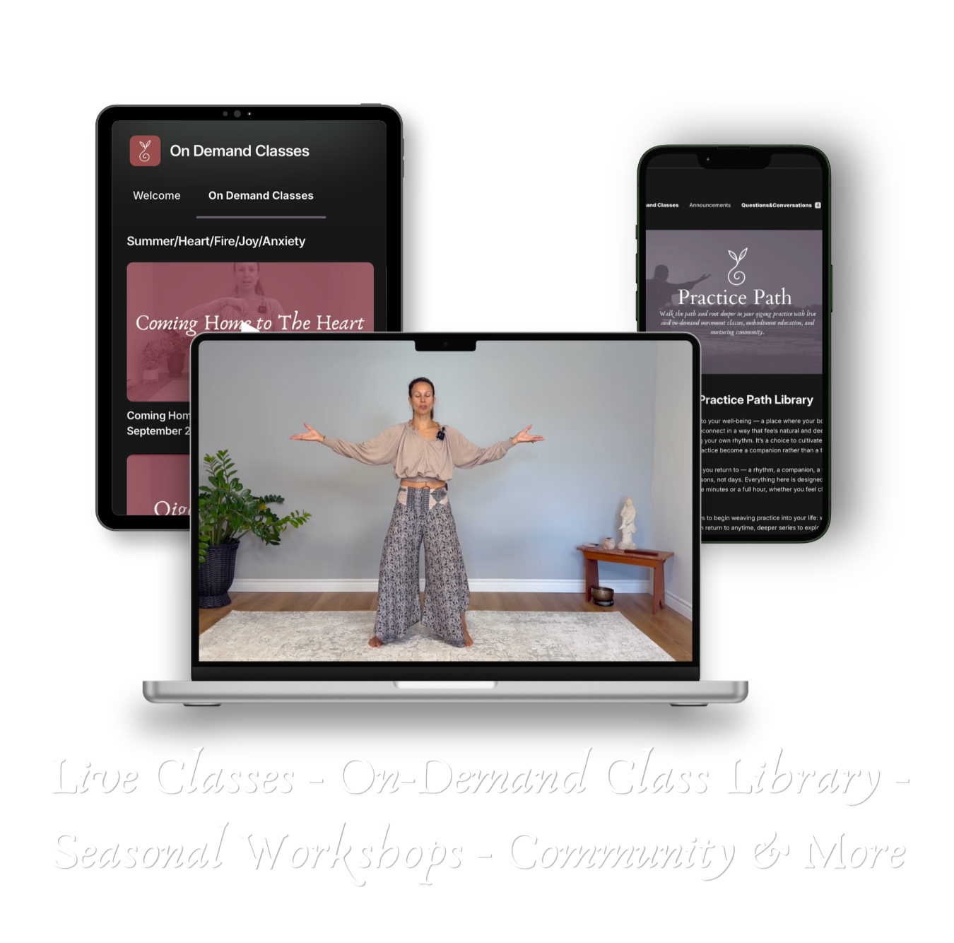 A woman standing on a laptop screen demonstrating a yoga pose with arms outstretched, in a room with a plant and a small wooden table with decorative items. Behind her is a plain wall.