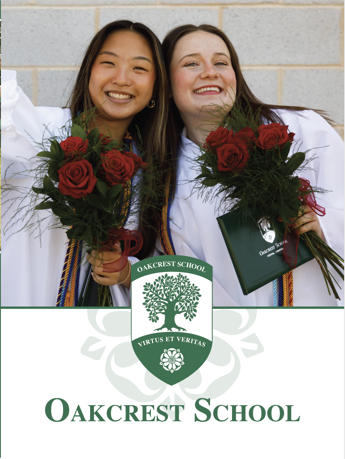 Two female students in graduation gowns holding bouquets of red roses, standing in front of a brick wall, with the Oakcrest School logo and name in the foreground.