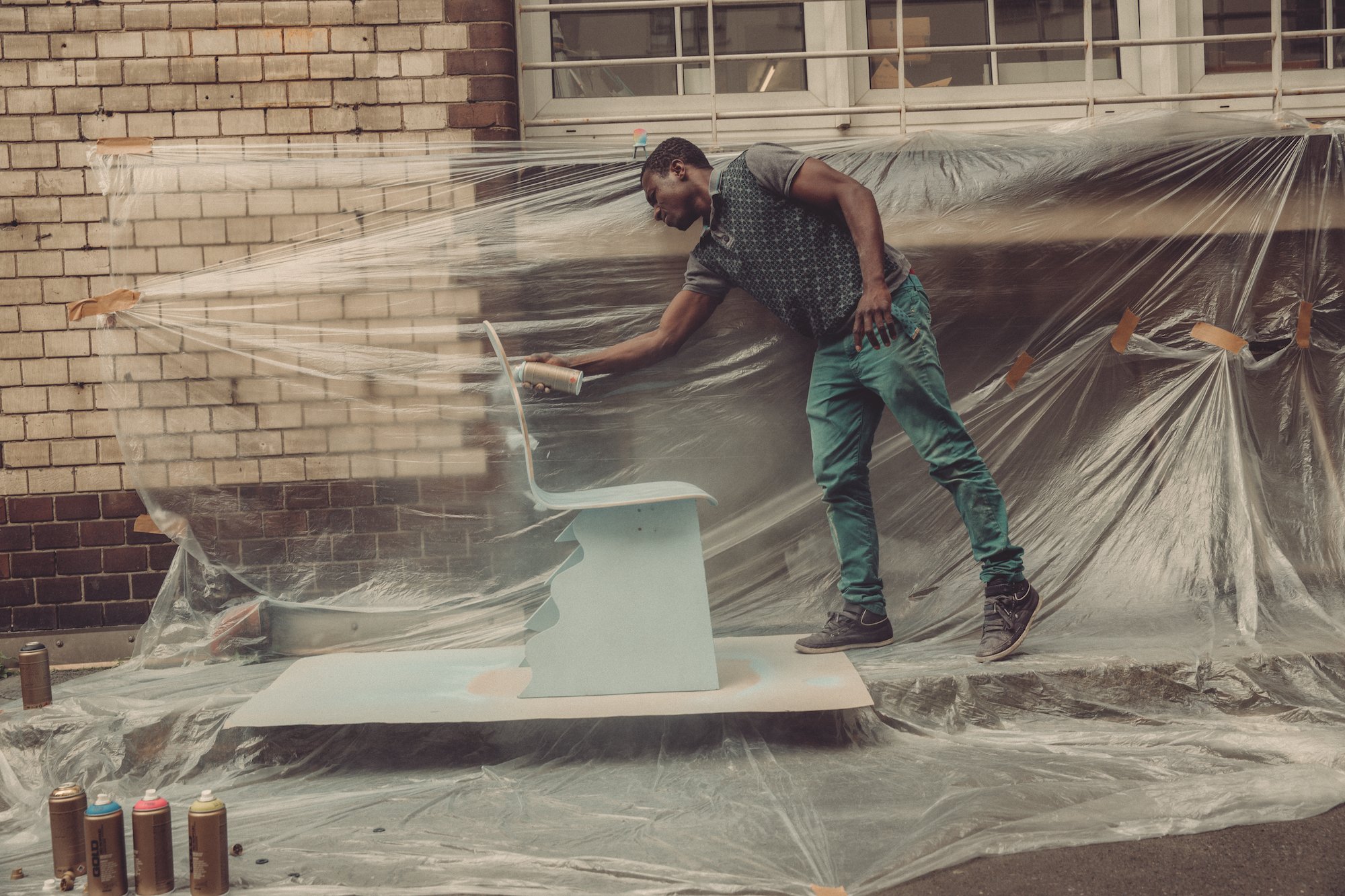  Yousuf Karim spraying a design in the Cucula courtyard. 