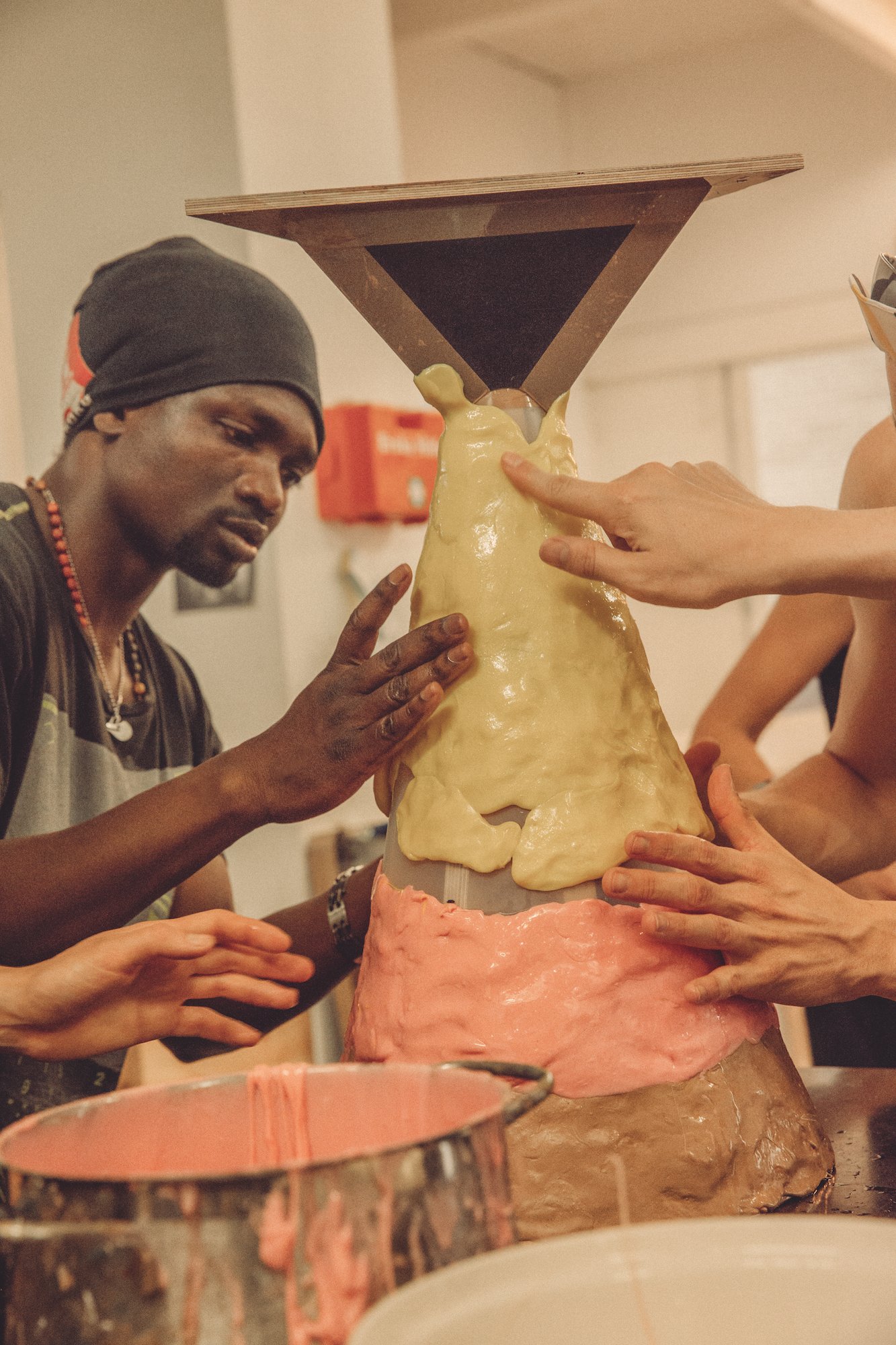  Ousmane Ba and others apply hot polycaprolactone wax onto the moulding form. 