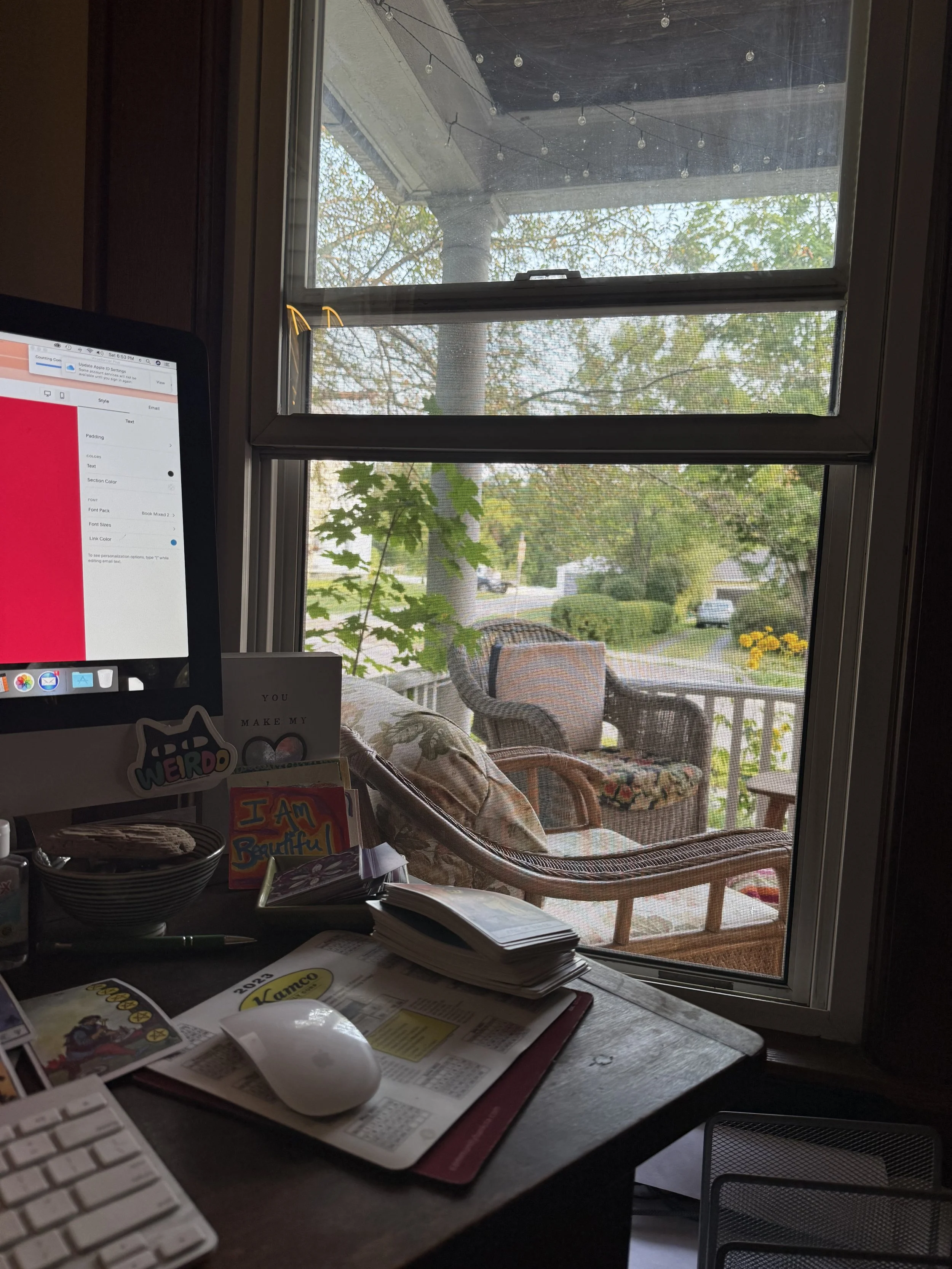 A desk for writing next to a window that opens onto a lovely porch,