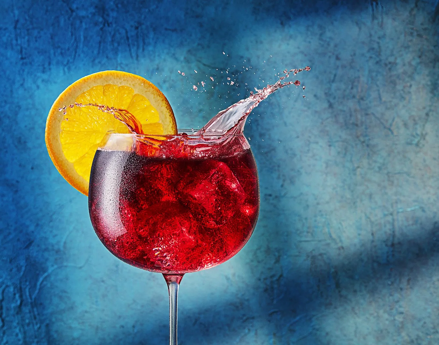 Seattle-Beverage-Photographer-Mike-Gluckman-Sangria-Splash

Large wine glass of sangria an ice splash and an orange wheel garnish. Background is blue stucco with warm window pattern. Bright and vibrant lighting. Seattle cocktail photography by Mike G