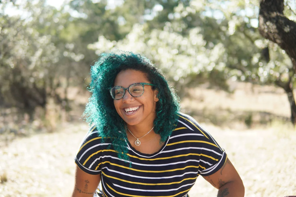 Madison Butler laughing in an outside space.