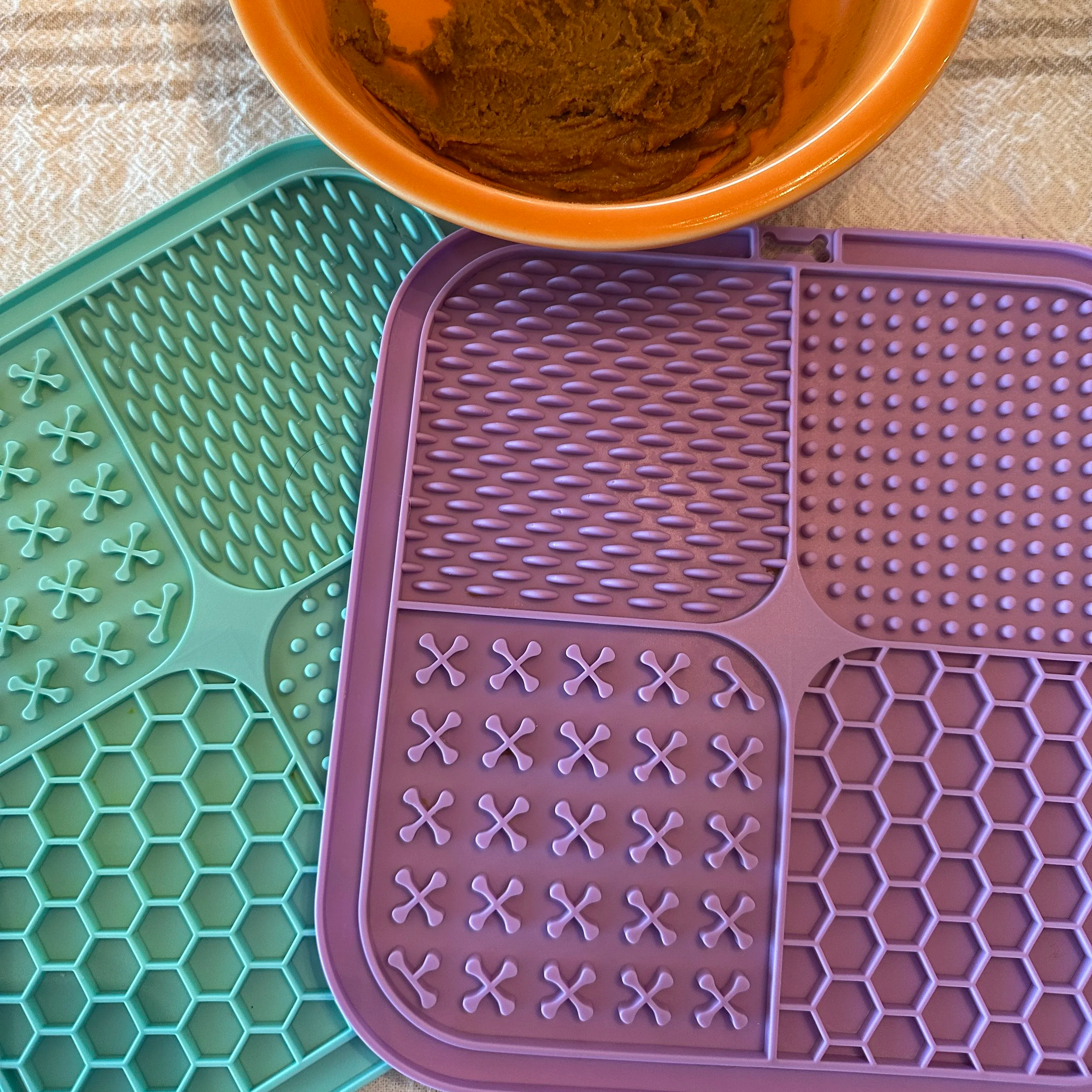 Two dog lick mats with peanut butter