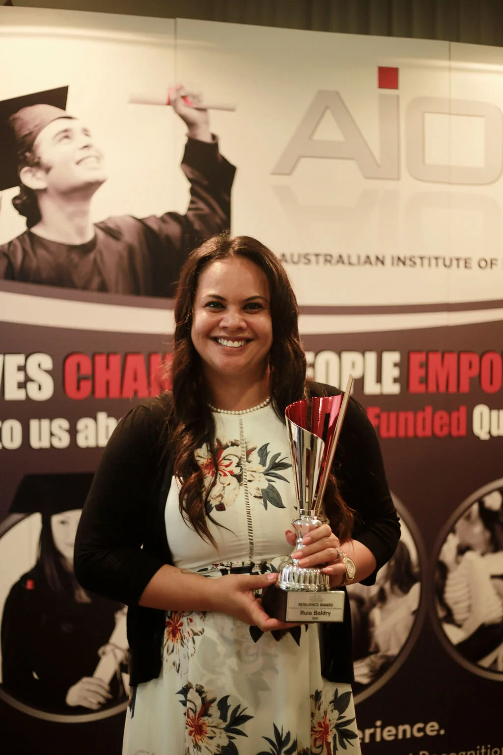 Ruie Boldry holding an Australian Institute of Learning Resilience Award
