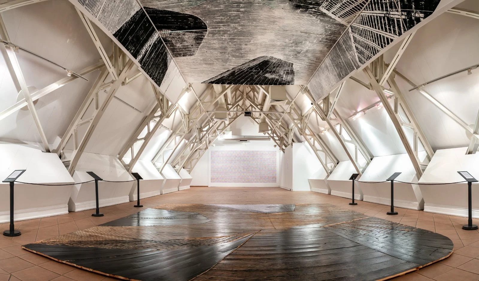 Geometric abstraction and urban form in ceiling woodcut panels by Gábor Koós, USA Diary series.