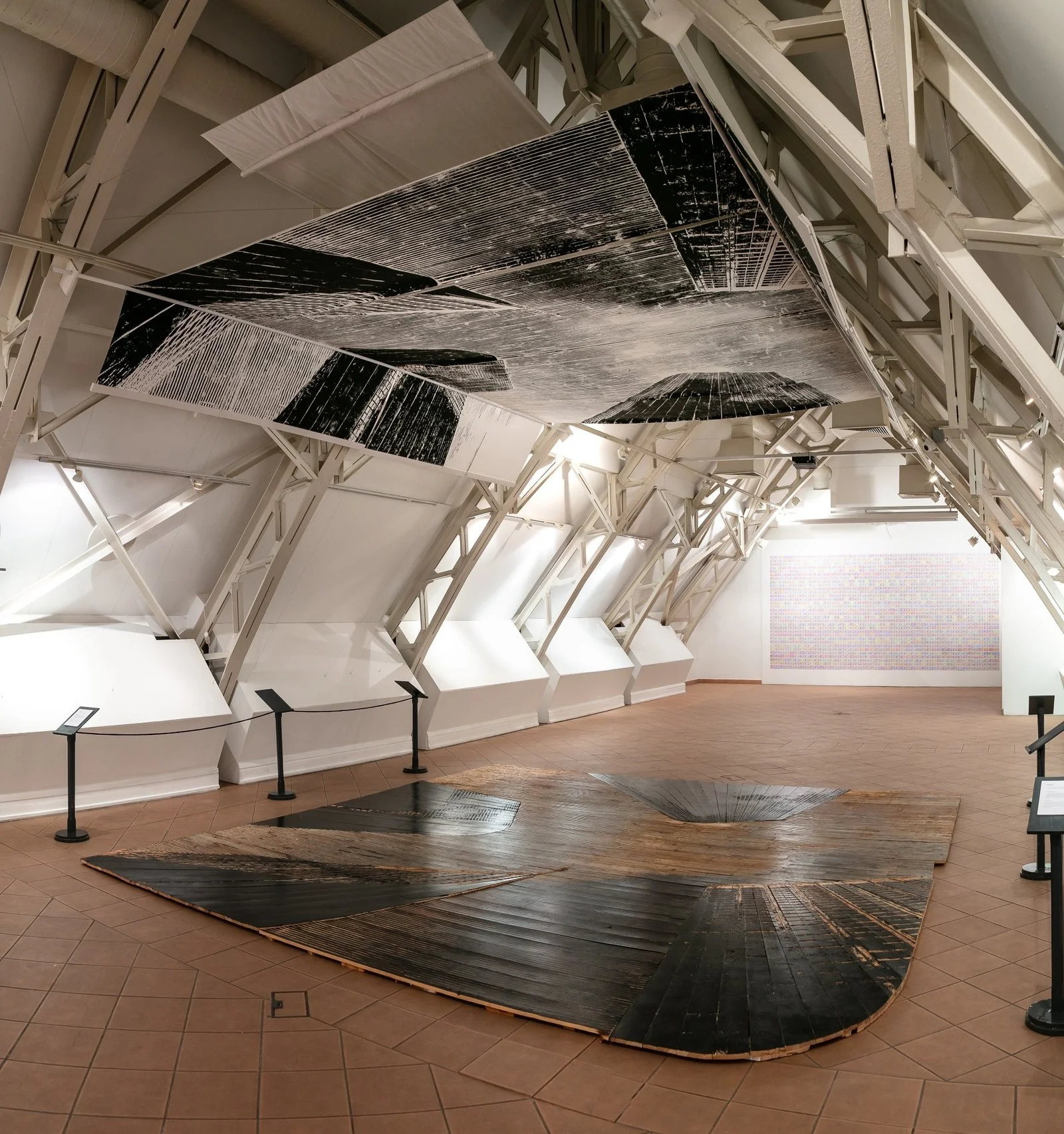 Close-up of USA Diary floor installation by Gábor Koós, linear carved wood textures.