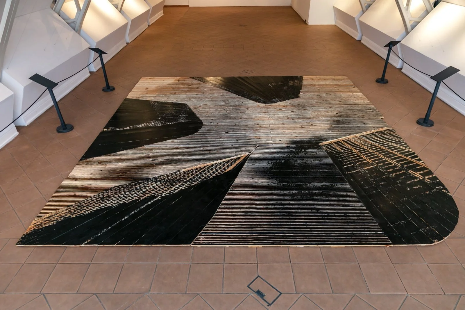 Detail of abstract skyscraper motifs carved into wooden floor panels by Gábor Koós.
