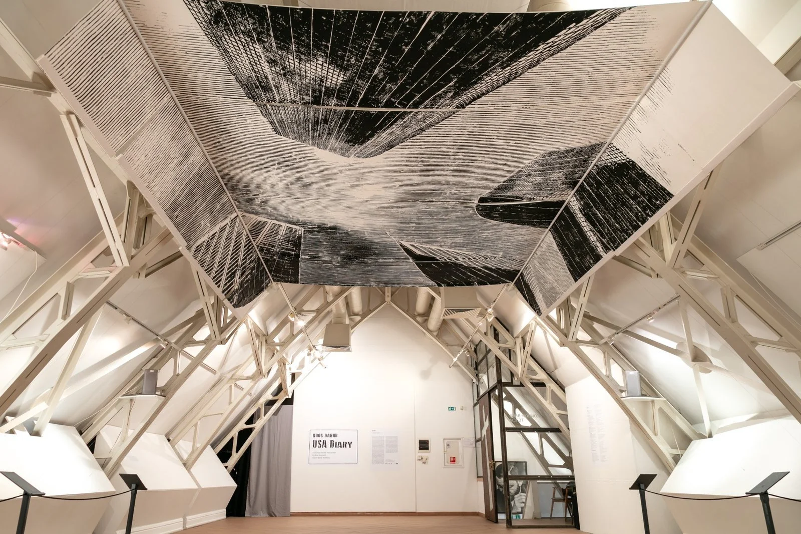 Woodcut ceiling print detail of urban skyline, part of Gábor Koós’ immersive USA Diary installation.