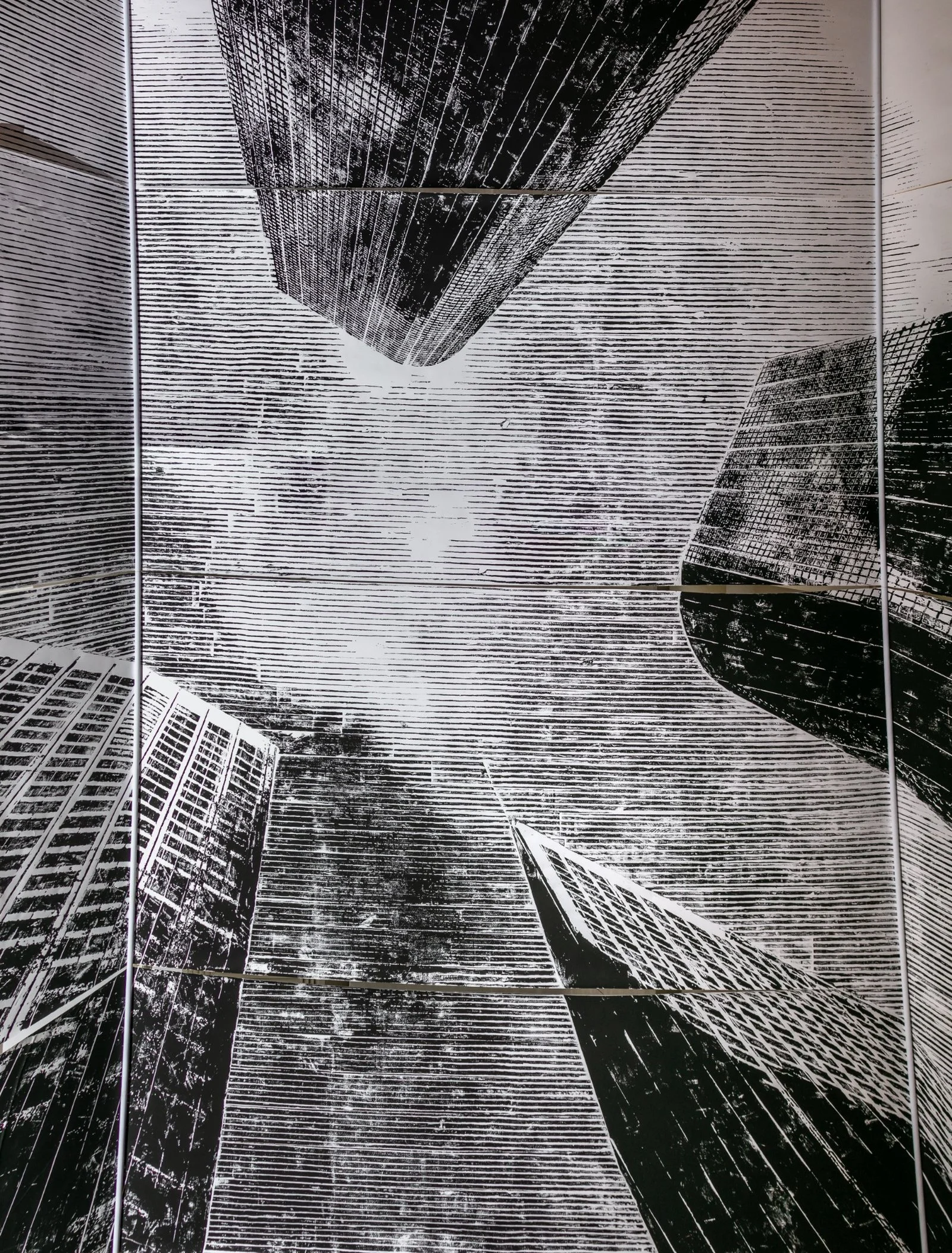 Detail of Koós’ architectural woodcut installation capturing urban geometry in a gallery setting.