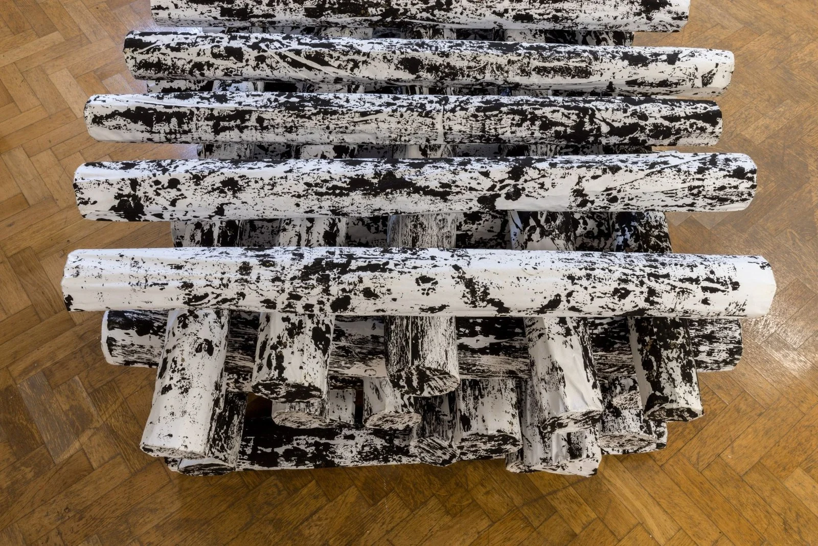 Top-down view of Koós’s sculptural frottage logs examining domestic heating solutions in Aleșd