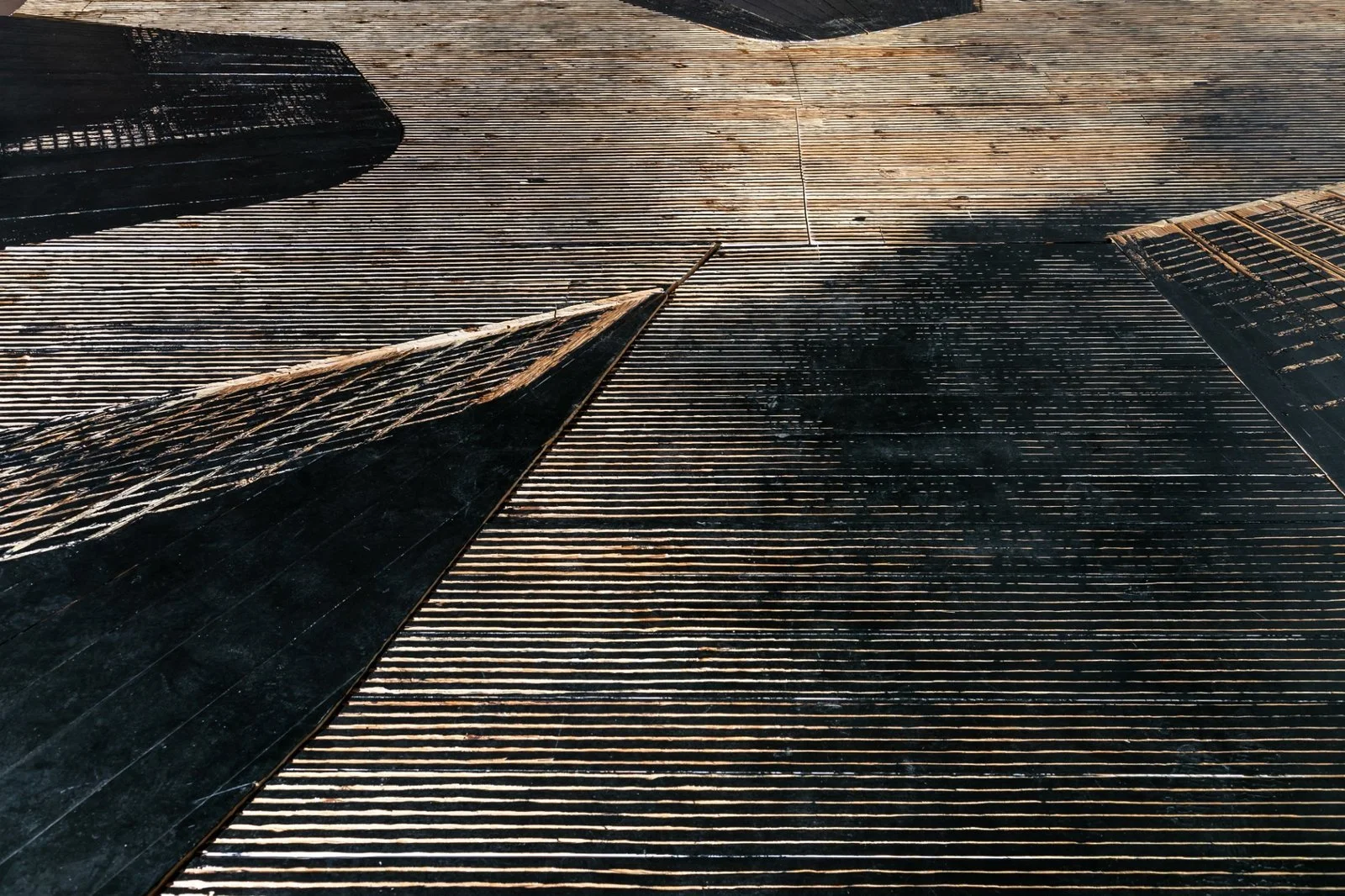 Upward perspective of a site-specific ceiling installation showing high-rise silhouettes by Koós.