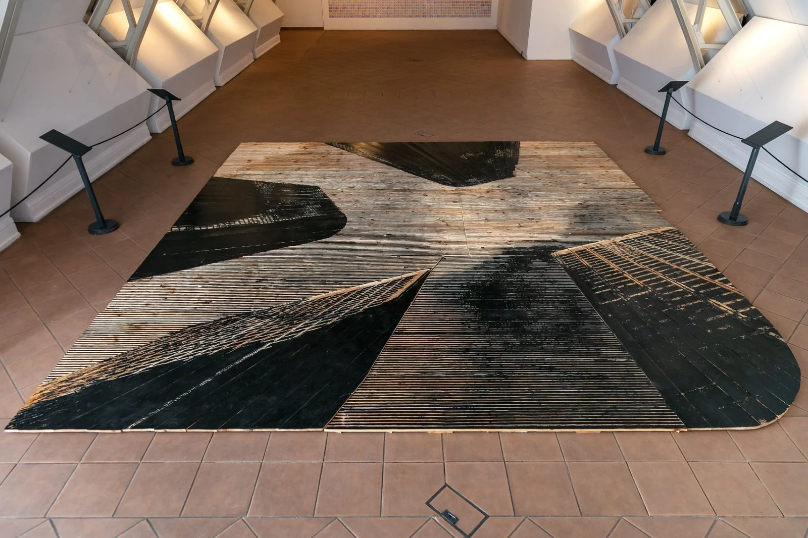 Symmetrical woodcut floorwork by Gábor Koós, part of USA Diary at Miskolc Gallery.