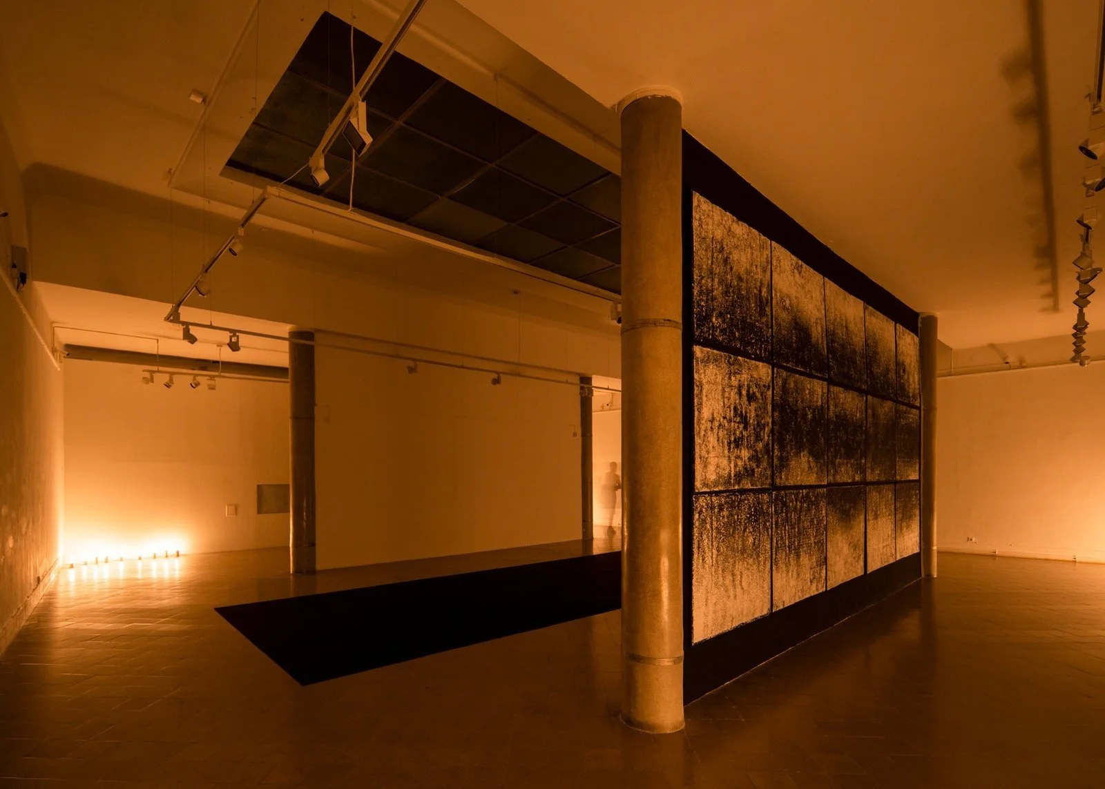 Gábor Koós' "Gazing into Darkness" installation view – large-scale modular wall with black pigment under ambient light