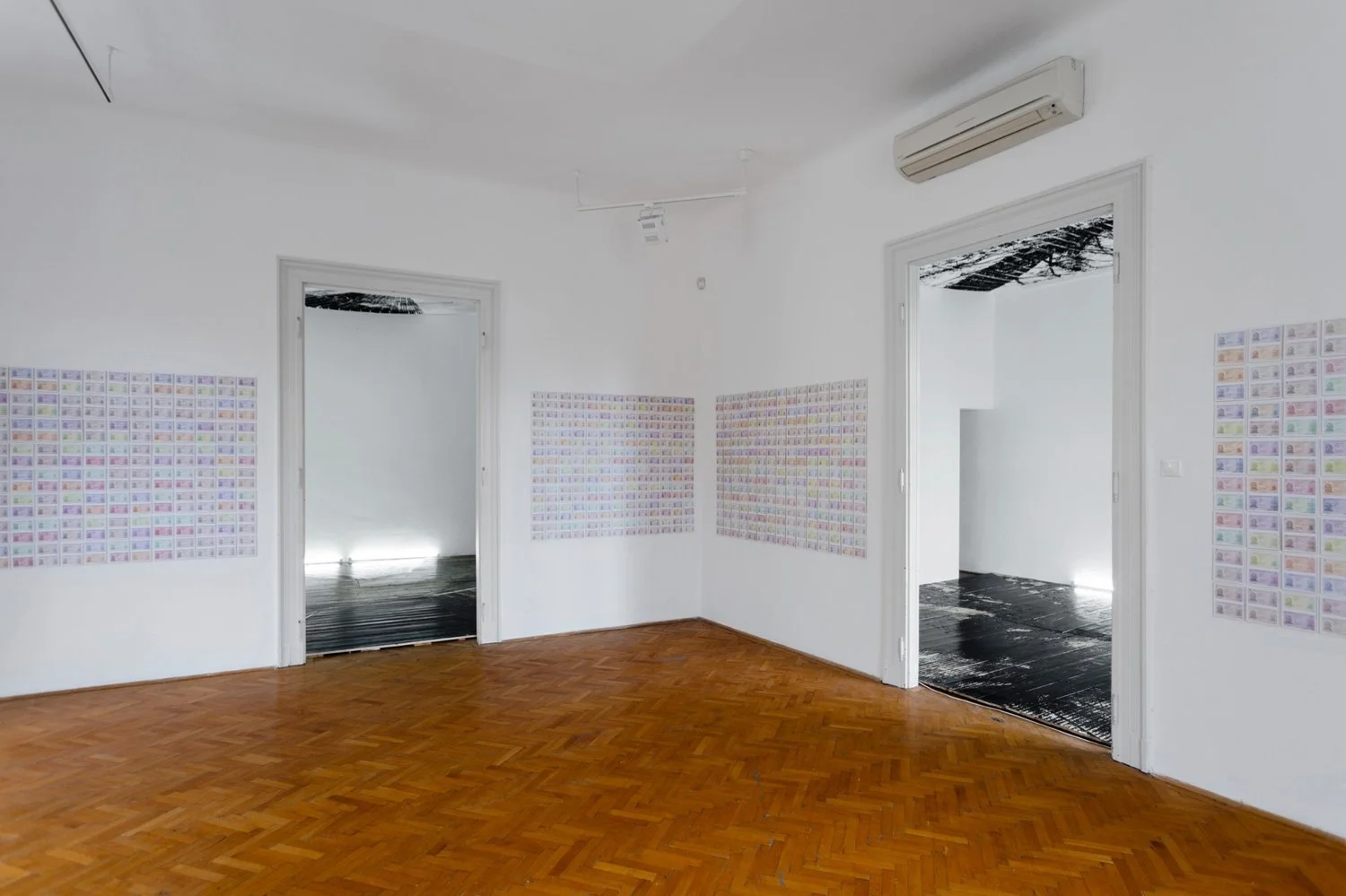 Corner wall display of ID-based installation by Gábor Koós, transitioning into woodcut print environments