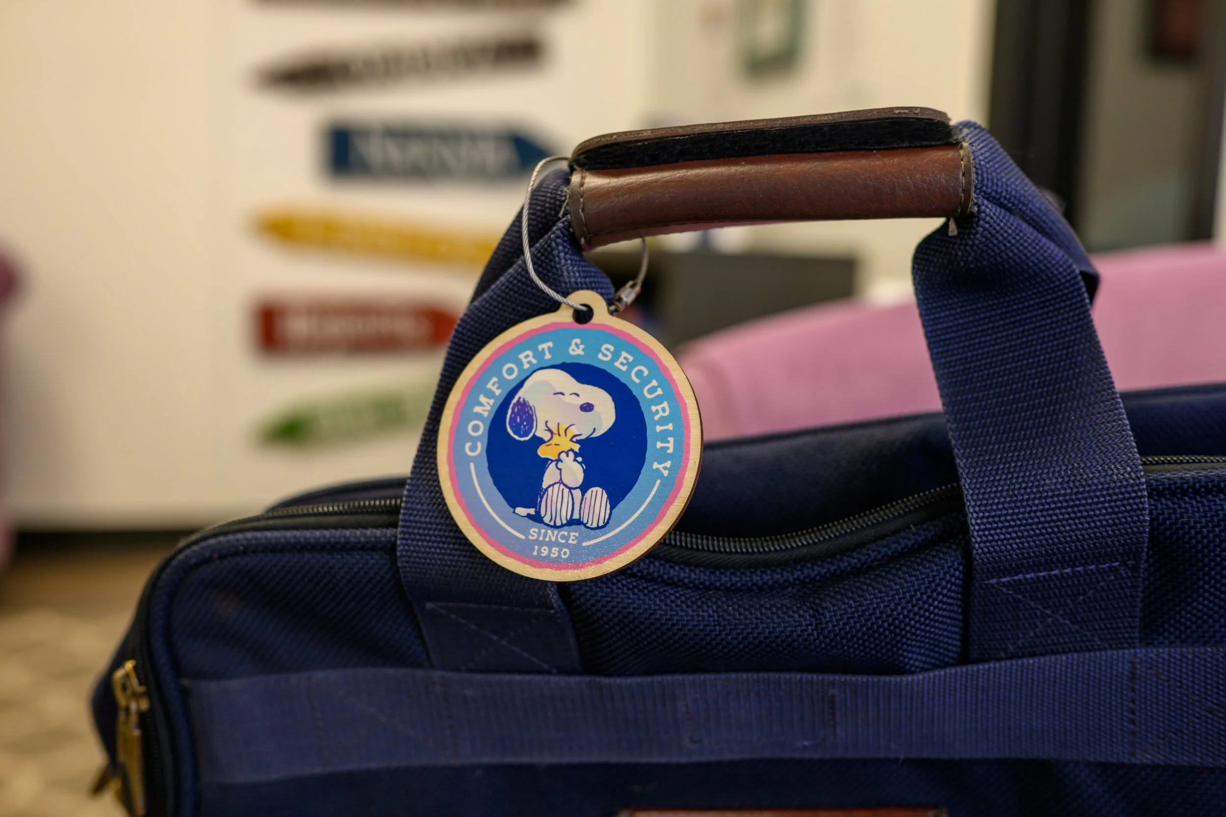 Description
Carry a little warmth and nostalgia wherever you go with the Peanuts “Comfort & Security” Wooden Bag Tag, featuring a heartwarming image of Snoopy cuddling Woodstock. Highlighting the iconic bond and timeless charm of the Peanuts characte