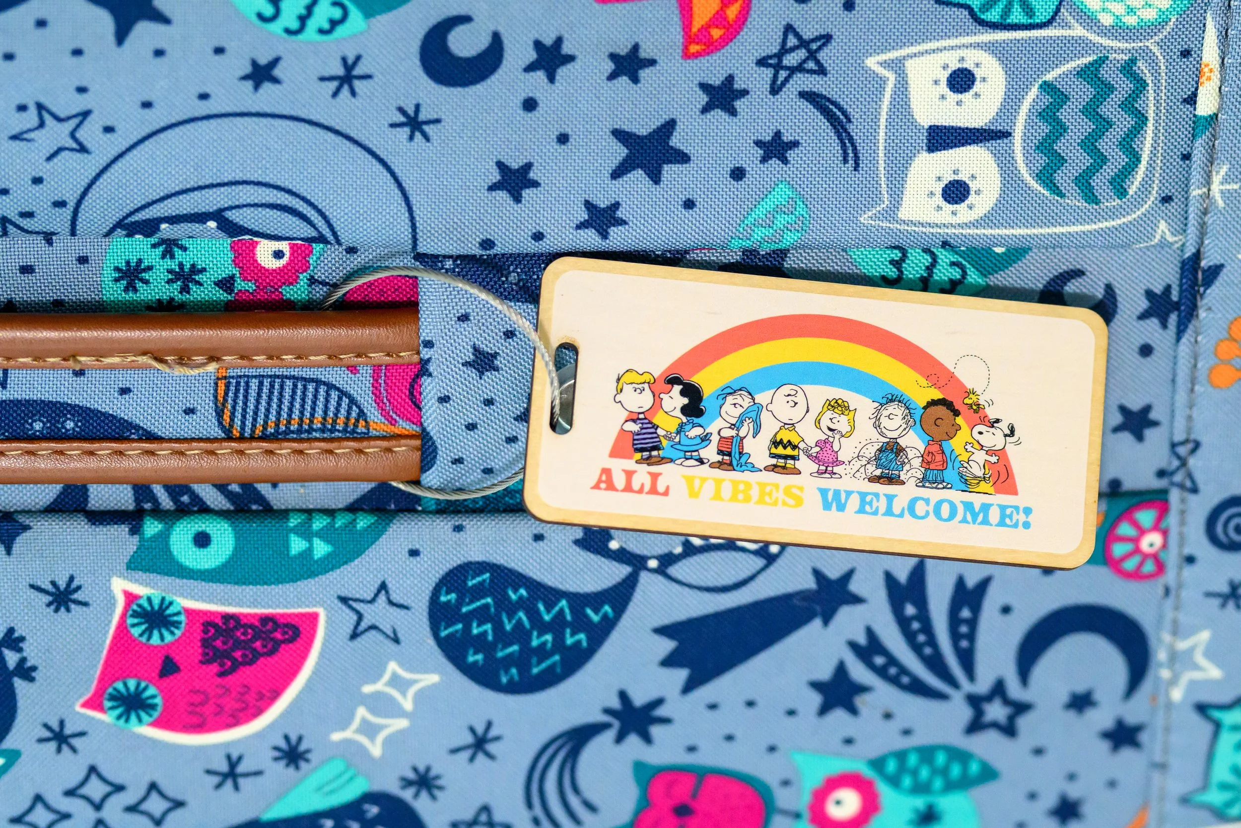 Celebrate inclusivity and joy with this vibrant Peanuts “All Vibes Welcome” Wooden Bag Tag! Featuring the whole Peanuts gang under a cheerful rainbow, this eye-catching tag measures 1.85" x 4" and is crafted from durable wood for long-lasting use.

P