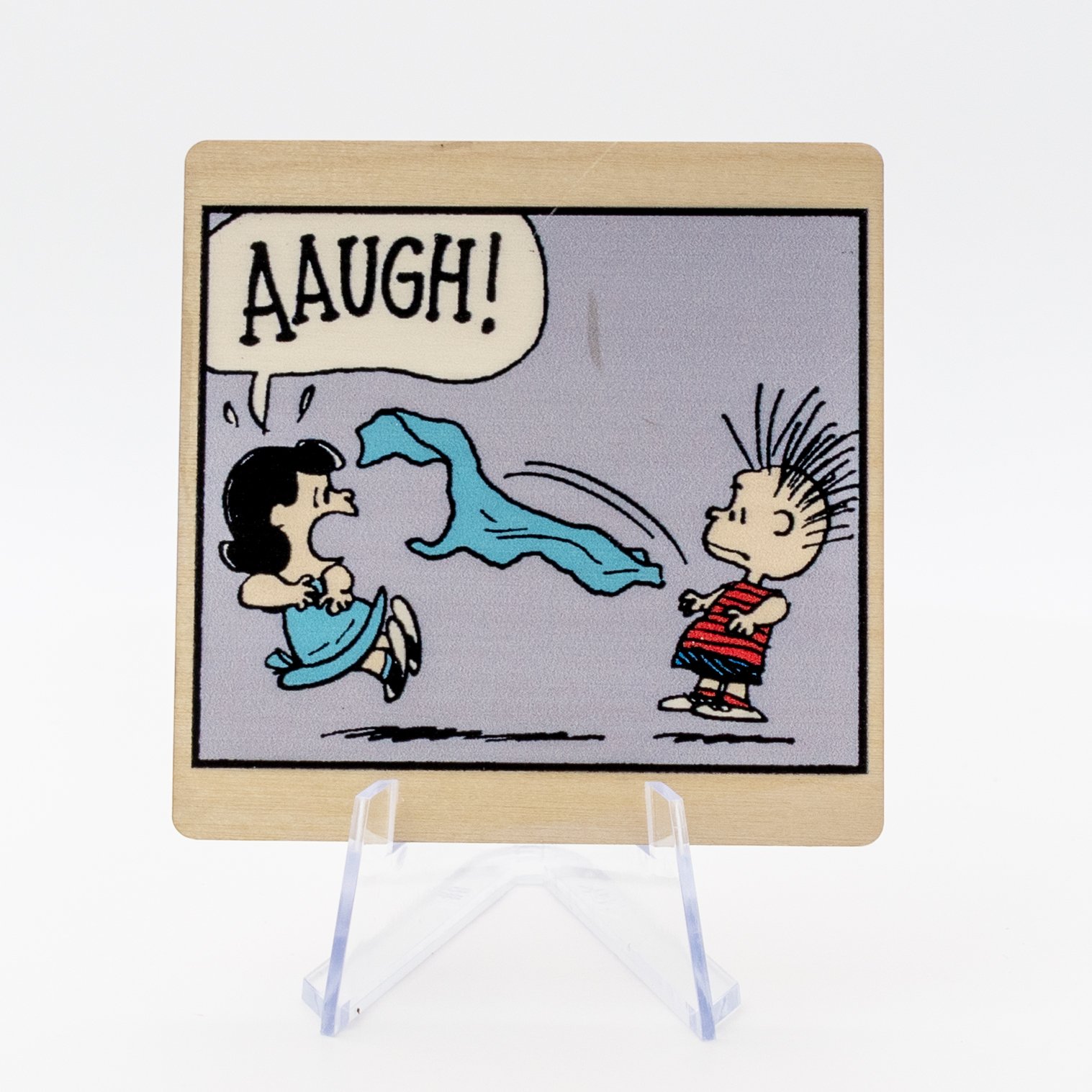 Bring a burst of classic Peanuts™ humor to any space with this charming wood magnet featuring an unforgettable “AAUGH!” moment between two beloved characters. Printed in crisp detail on natural wood, this magnet adds a fun, nostalgic touch to refrige