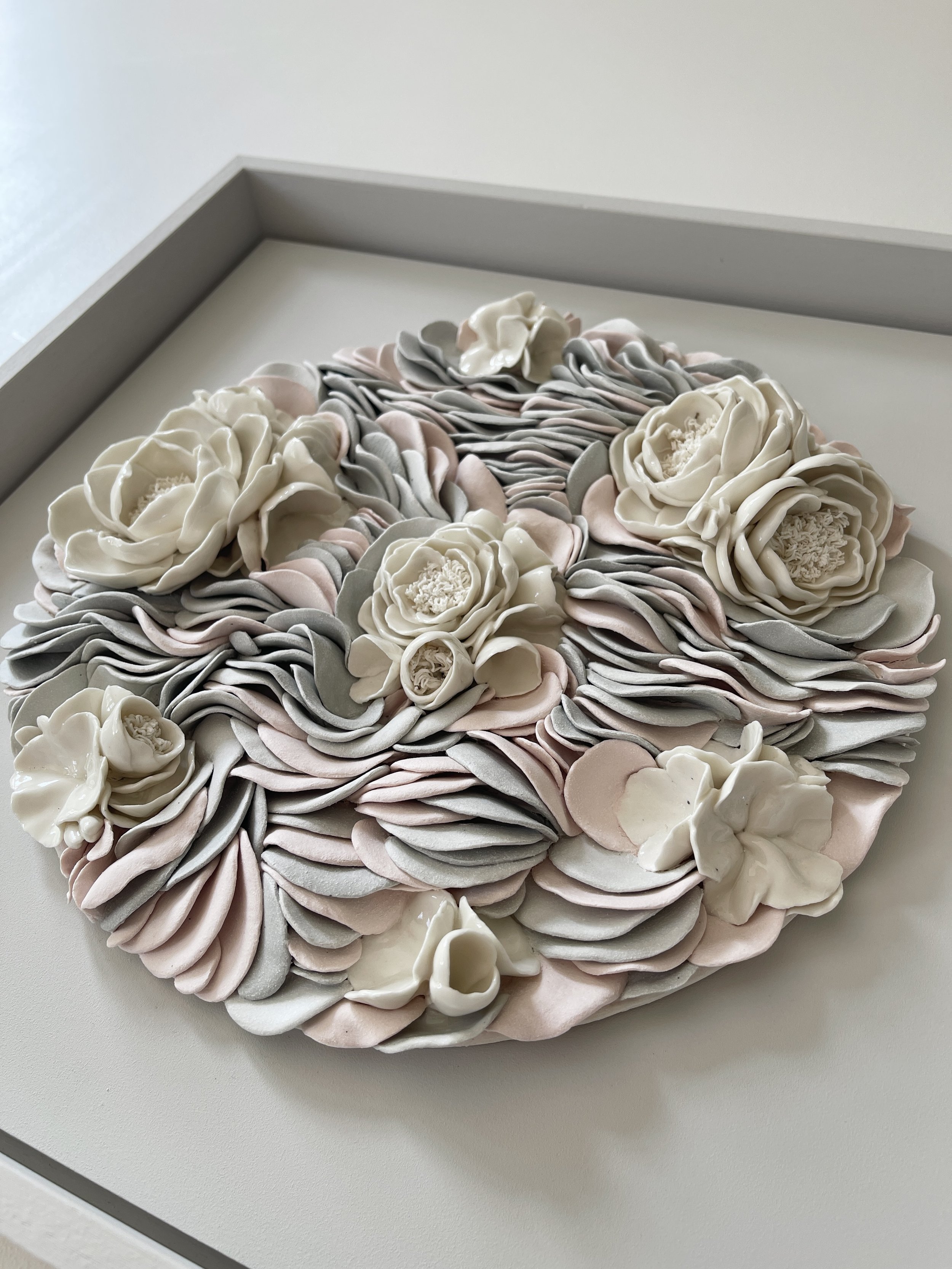 Side angle view of Floral Ripples showing the sculptural depth and layered porcelain forms.