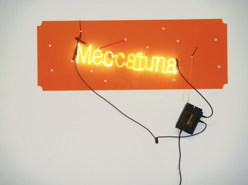 Jason Rhoades (1965 – 2006), Meccatuna , 2003, Neon light mounted on orange translucent Plexiglas, wire, lace, transformer, 17.2 x 47 x 1.5 in. (studio proof) Courtesy PFM Collection.