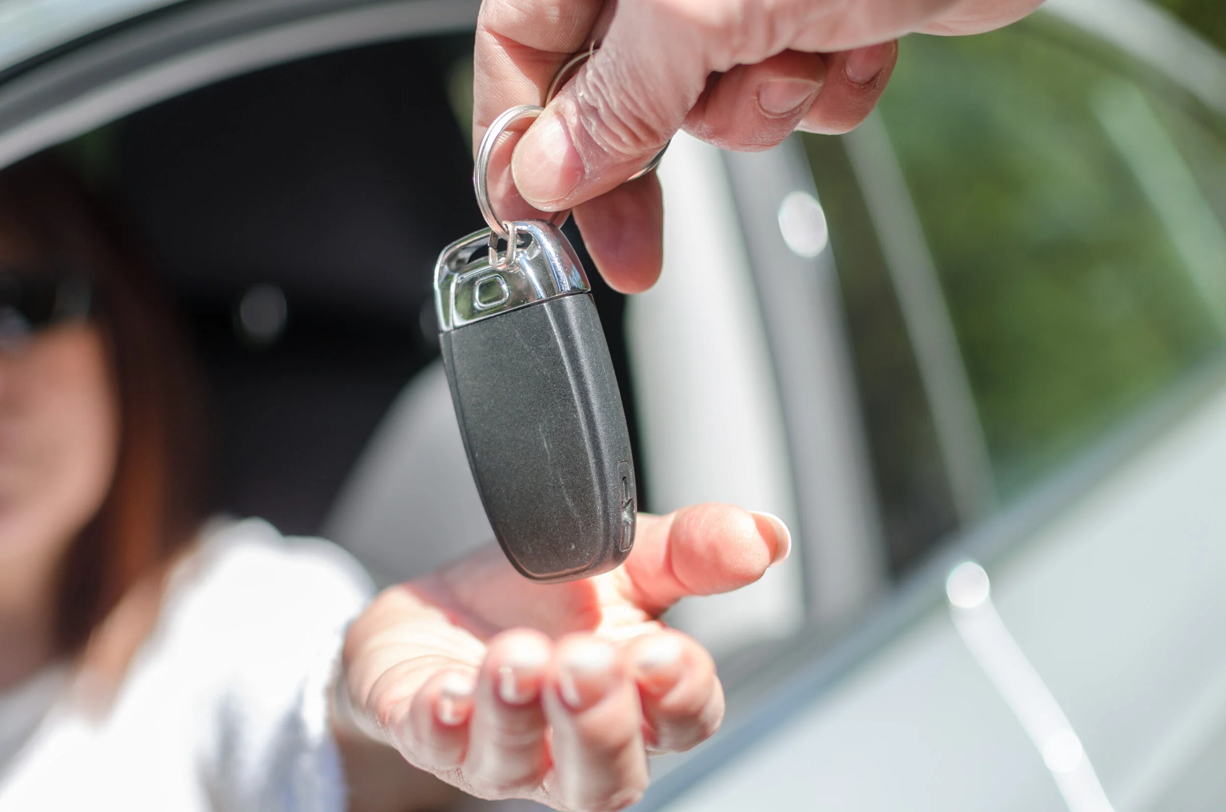 vecteezy_man-giving-car-key-to-a-woman_1177823.jpg