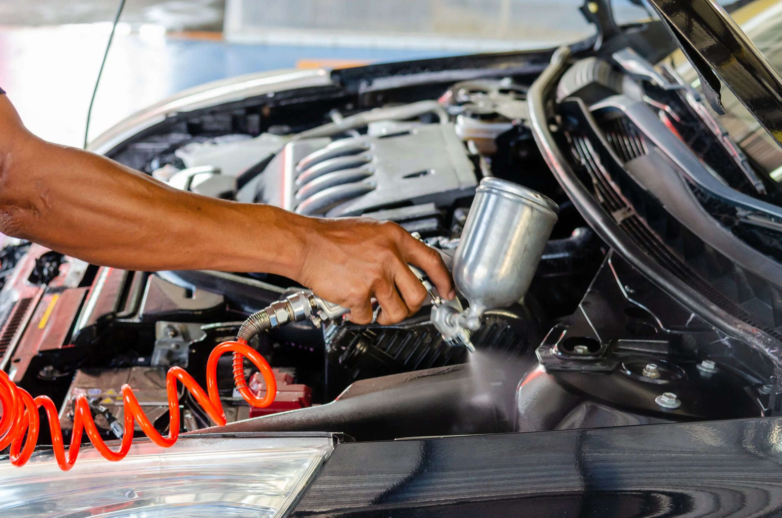 vecteezy_a-close-up-of-a-person-detailing-the-inside-of-a-car-engine_1430205.jpg