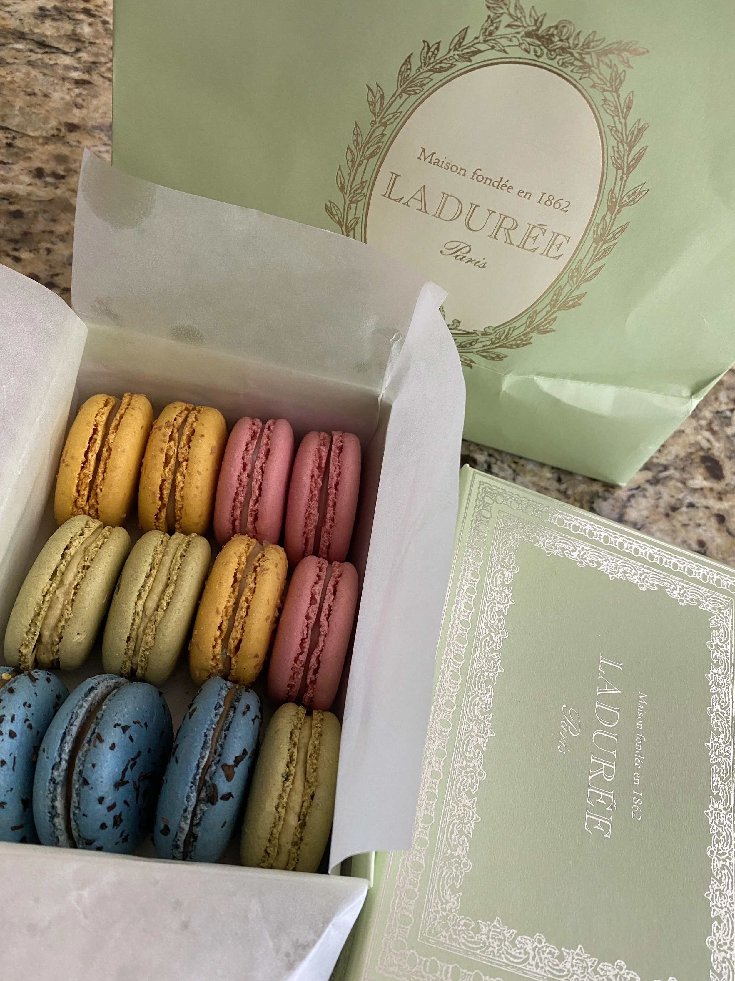 Ladurée Paris | Champs Elysées colorful macarons in their beautiful green and gold box