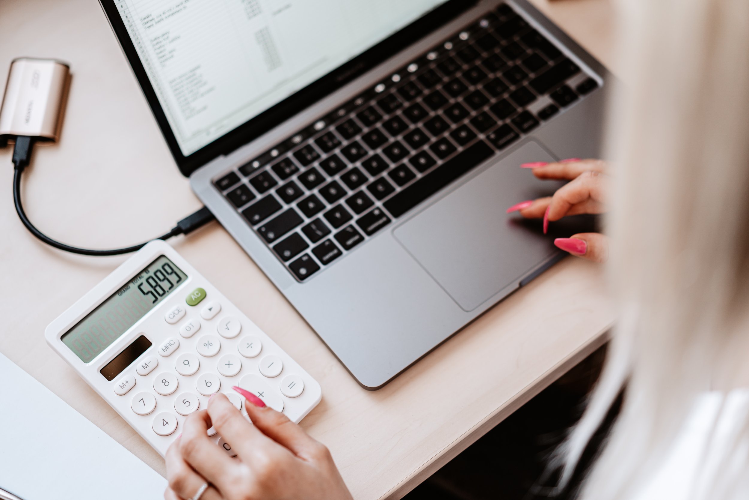 woman-working-on-a-laptop-and-calculator-picjumbo-com.jpg