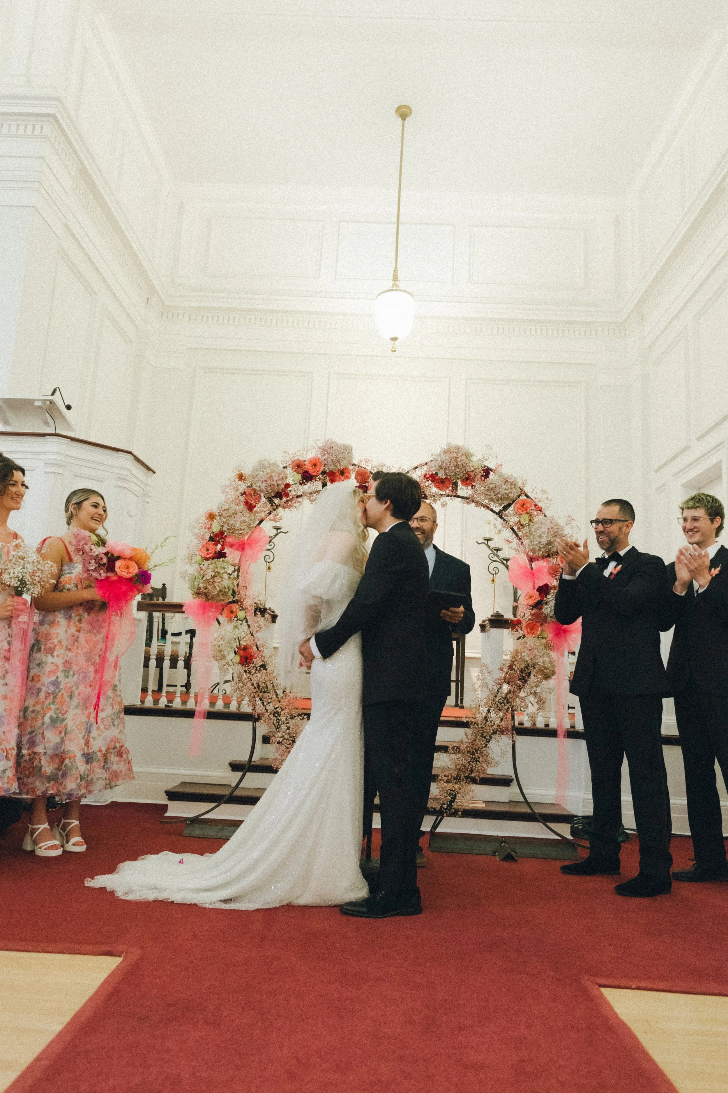 couple sharing first kiss at the alter