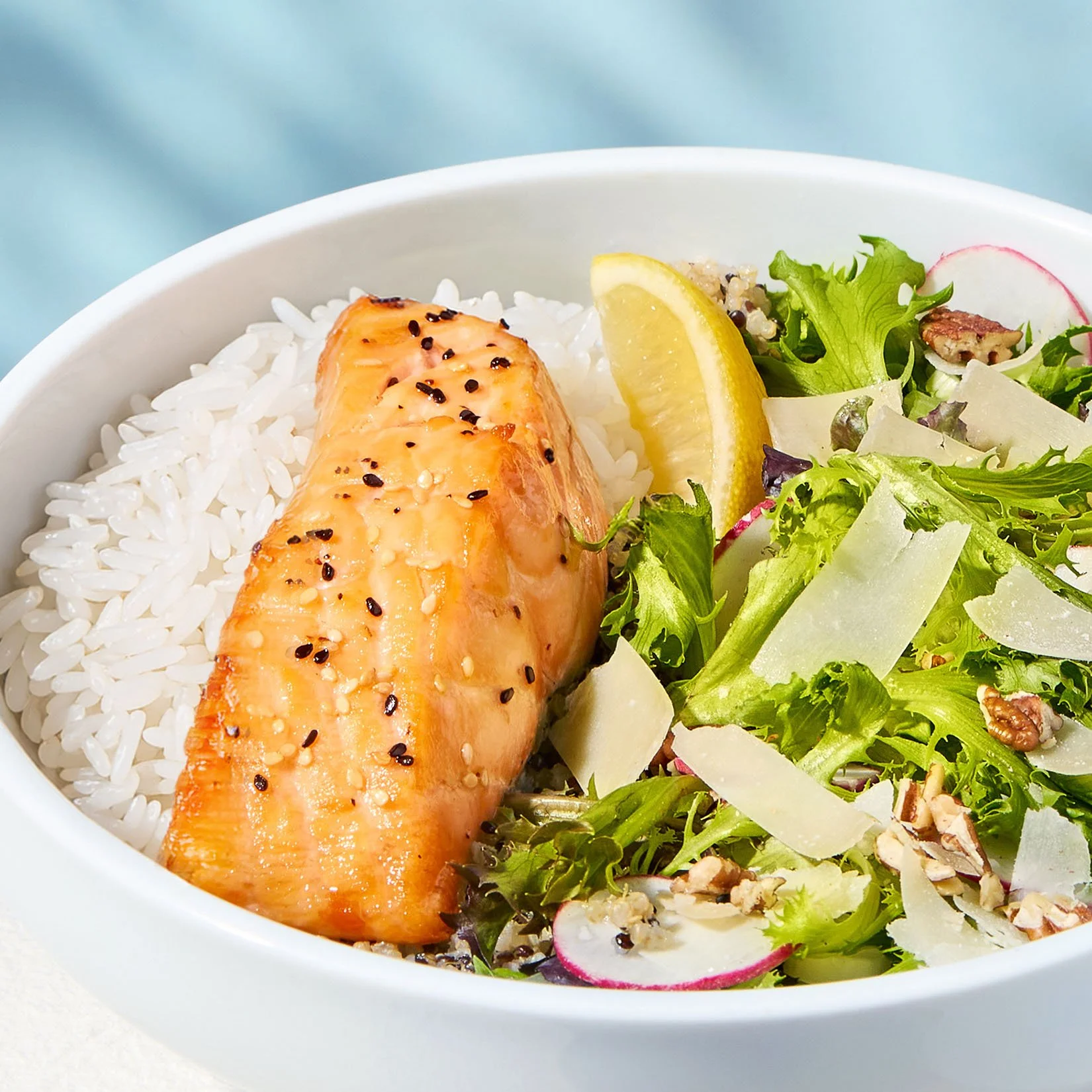 Protein plate with over roasted salmon, cilantro rice and side salad