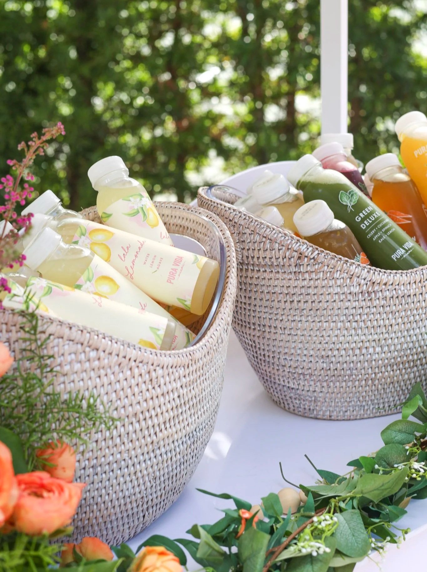 Assorted Pura Vida Miami cold pressed juices inside two buckets. 