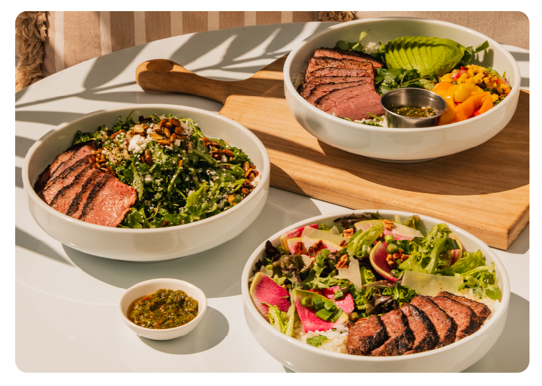 100% Grass-Fed Plate, Sunset Steak Bowl, and fresh salad with a Steak