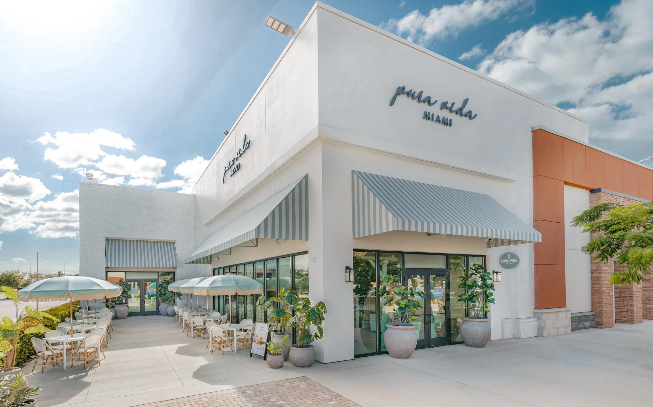 Bright and modern interior of Pura Vida Miami Beach serving organic coffee and healthy drinks.