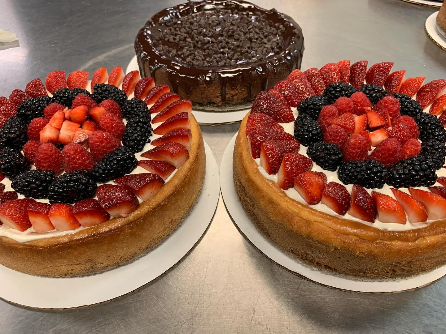 3 Large Cheesecakes Available &mdash;$55 each
(Left to right)

1) Vanilla Triple Berry (Vanilla filling, Vanilla Sour Cream, topped with Fresh Strawberries, Blackberries, and Raspberries
2) Chocolate Lover&rsquo;s (Chocolate Filling topped with Ganac