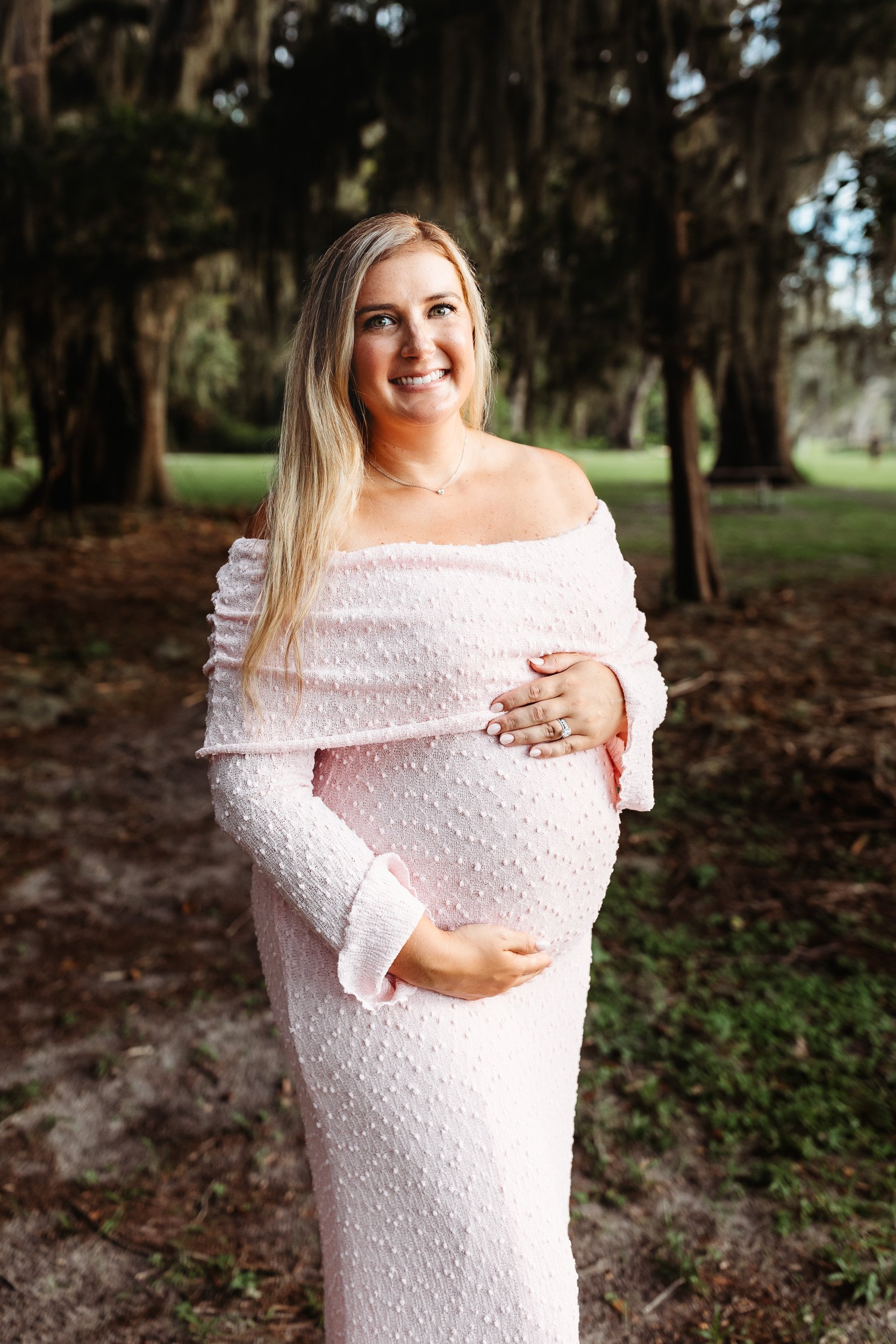 solo portrait of pregnant woman in a pink textured dress