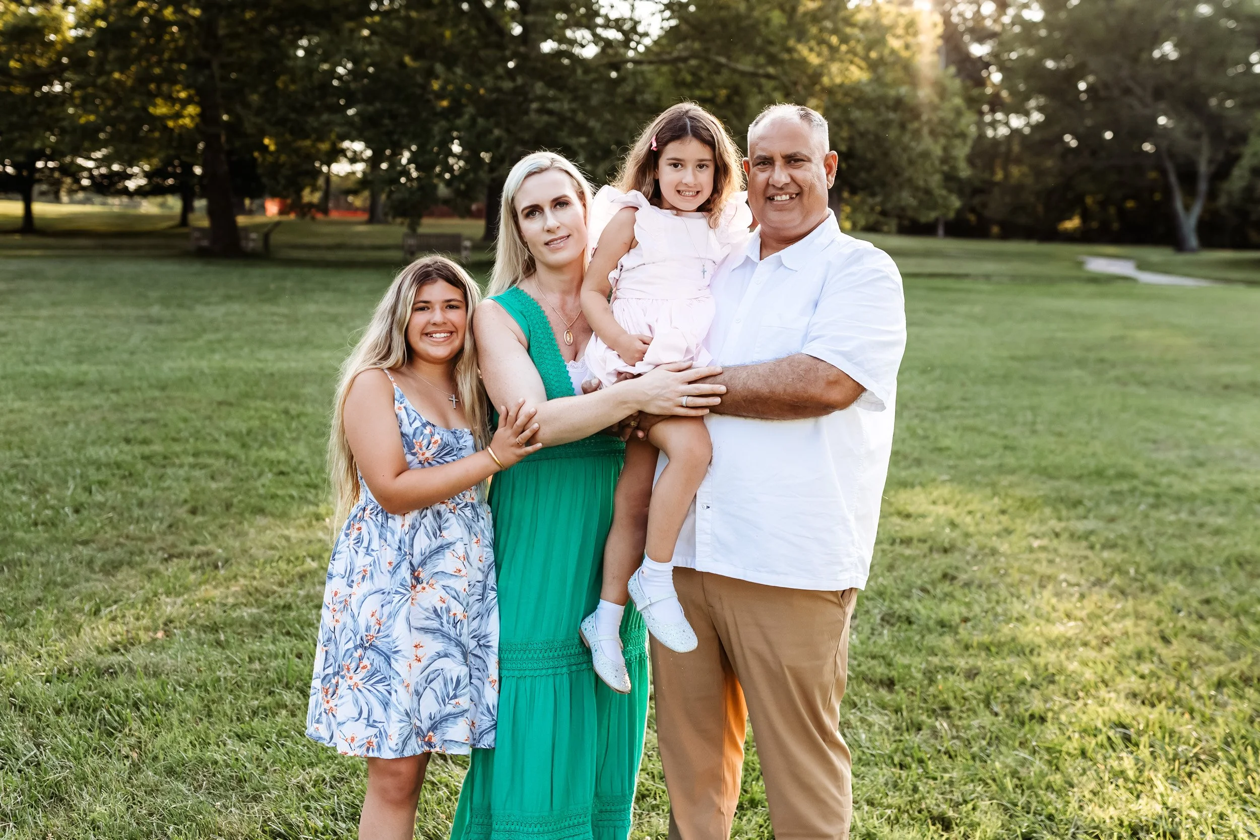family standing in a field at Walter jones park in Jacksonville for family photos