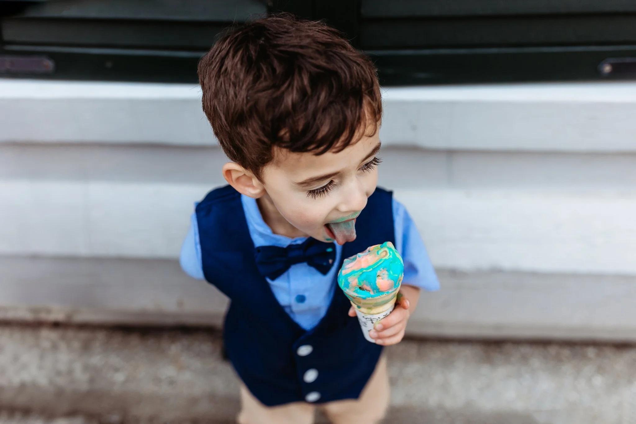 little boy eating an ice cream cone on st George street