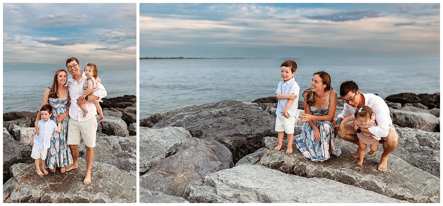 family kneeling on a jetty with toddler kids and beautiful cloudy bleu sky behind them