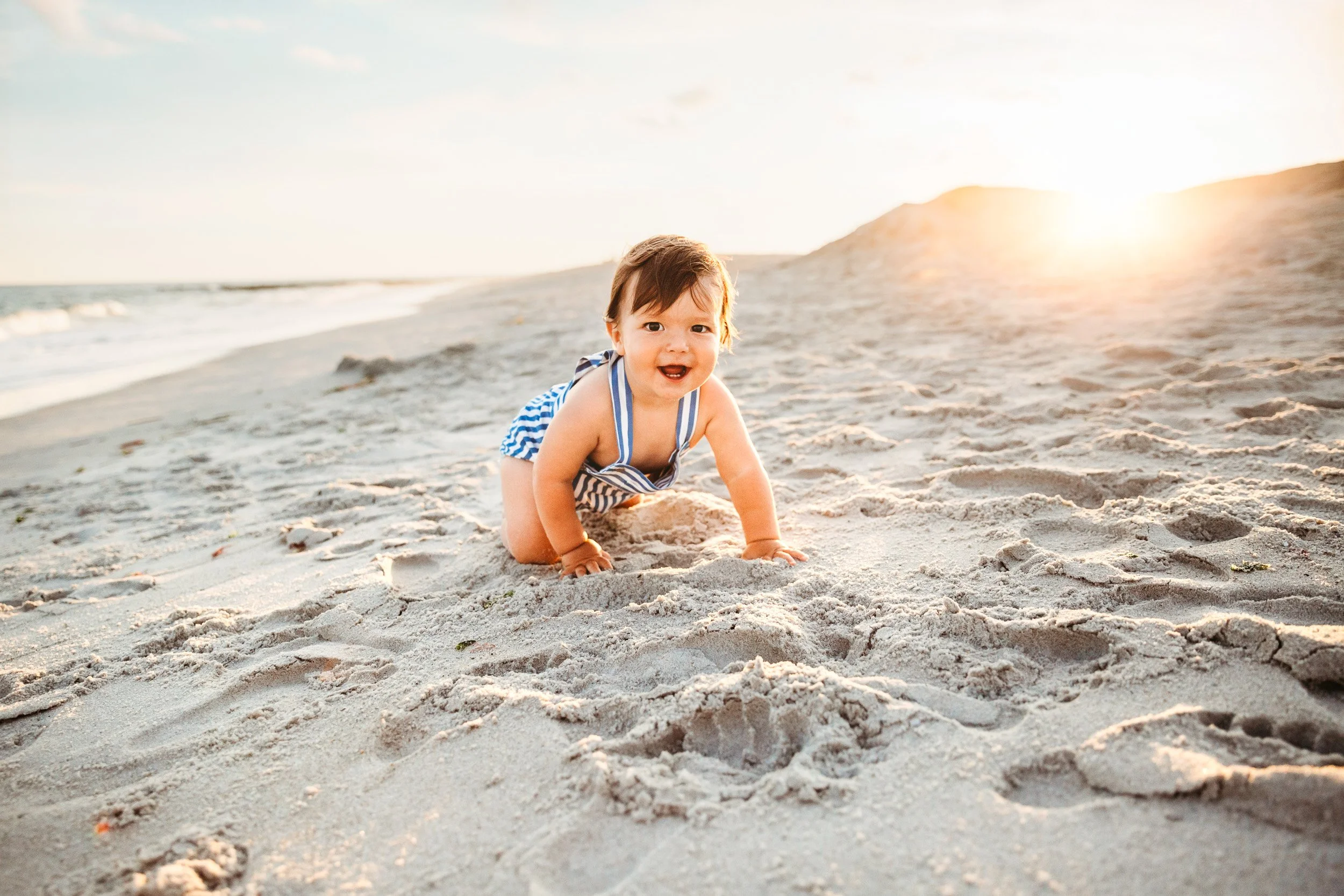 Baby crawling on the beach during a first birthday session in St. Augustine FL