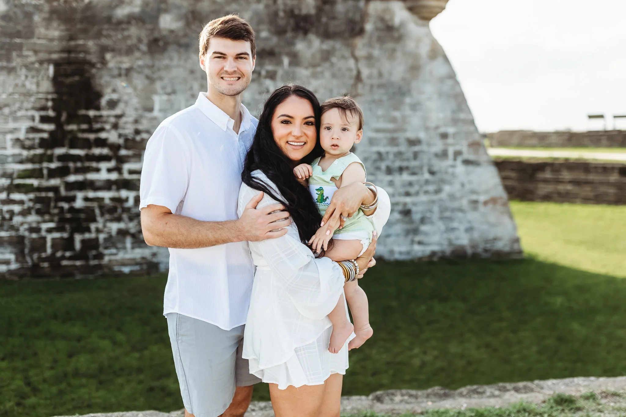 family with a baby in front of the fort in the morning at sunrise