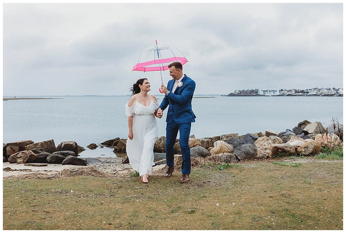 rainy day wedding ceremony with clear umbrella