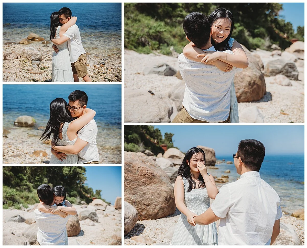 couple laughing and hugging after getting engaged on rocky beach in Jacksonville area with bright blue water
