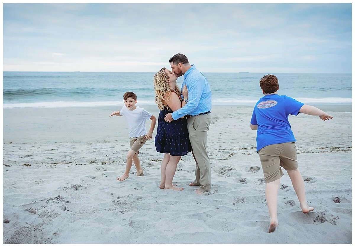 boys running in circles around mom and dad kissing