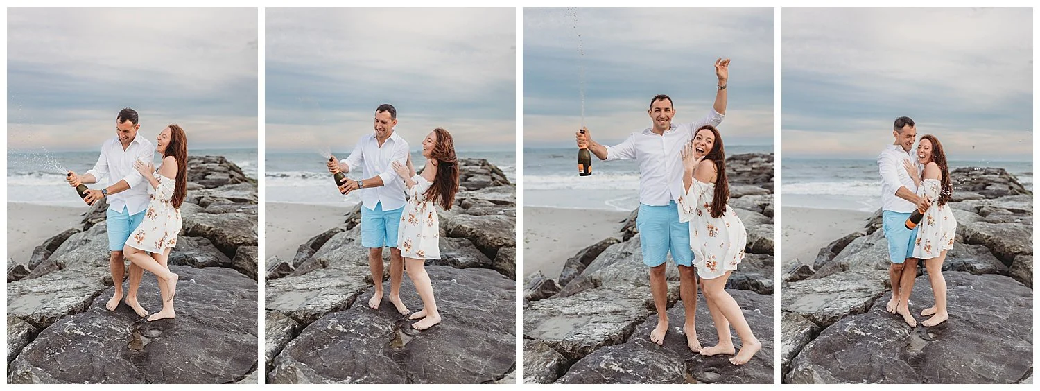 man popping ipen a bottle of prosecco on a jetty while girl laughs and the bottle sprays all over them